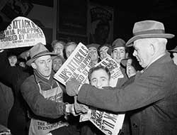 Newspapers announcing Pearl Harbor attack being sold in Times Square on December 7, 1941.